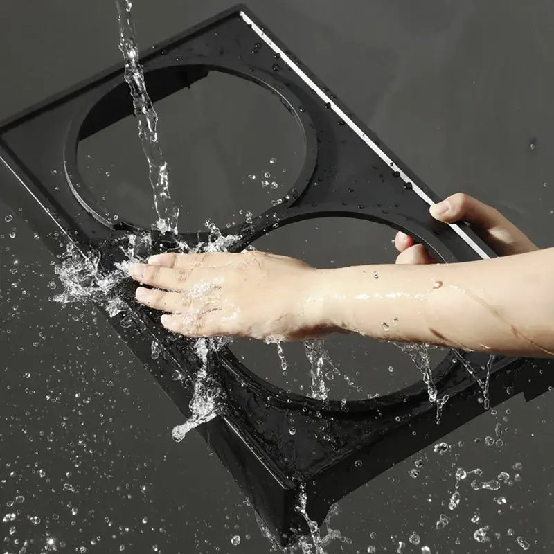 Bathroom scale being splashed with water as a hand touches it.