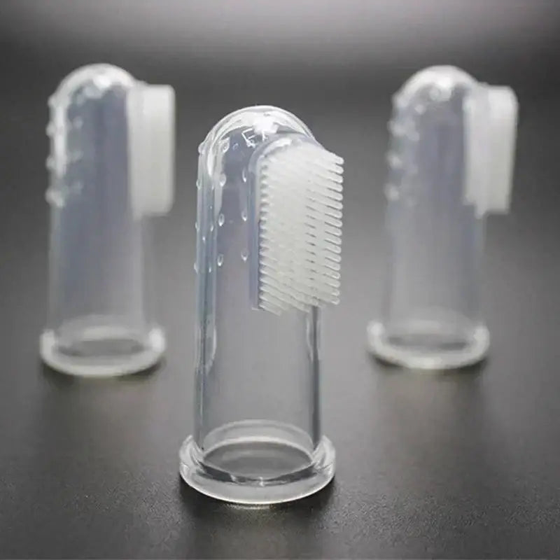 Silicone finger toothbrush with protective clear cover.