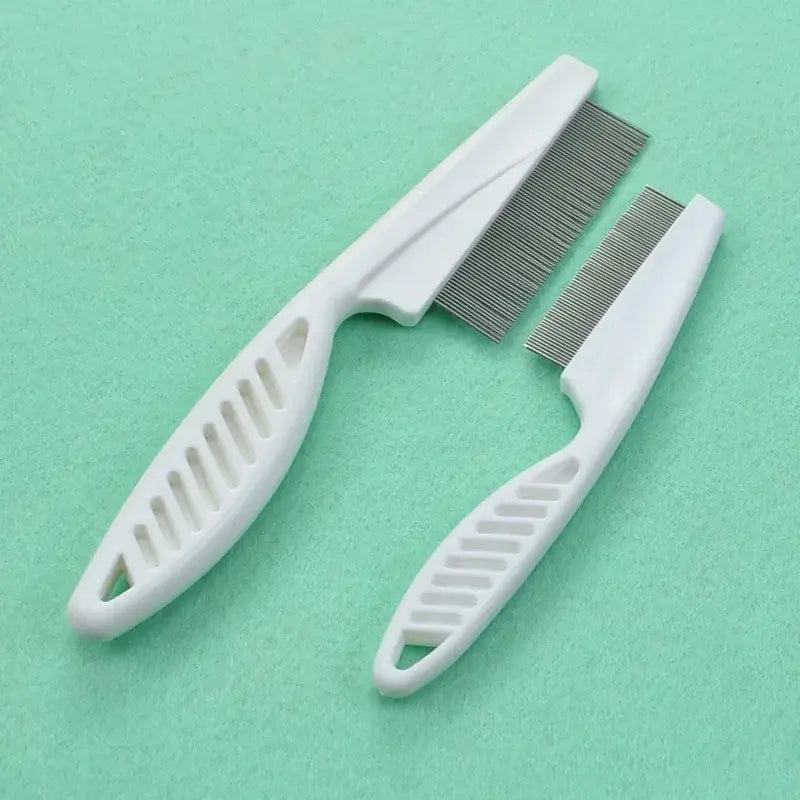 Pet grooming combs with white plastic handles and metal teeth.