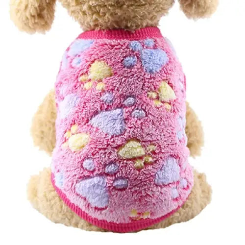 Fluffy pink dog sweater with pastel heart patterns.