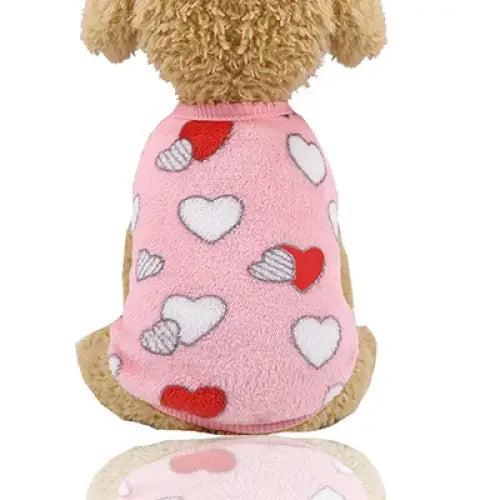 Pink dog sweater with heart patterns.