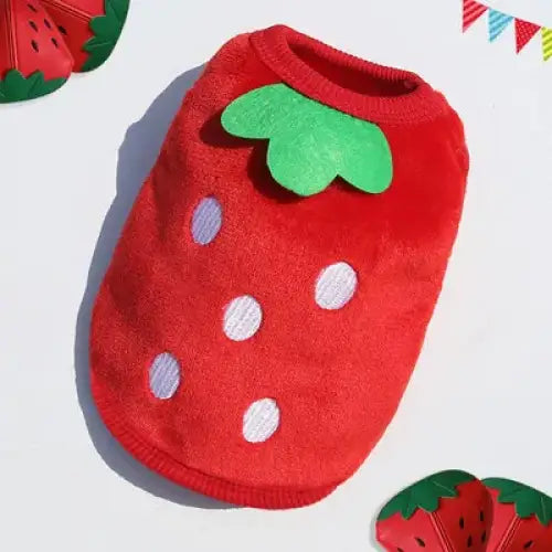 Red strawberry-shaped pet costume with white polka dots and a green leaf collar.