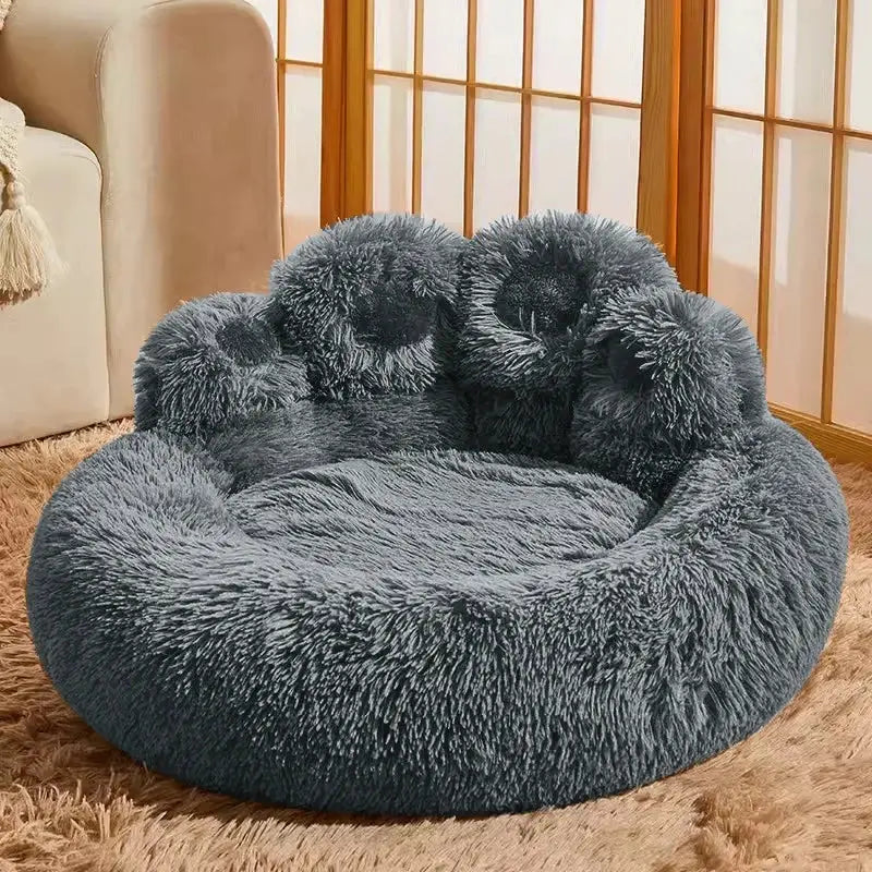 Fluffy, round, dark gray pet bed with a plush, donut-shaped design.