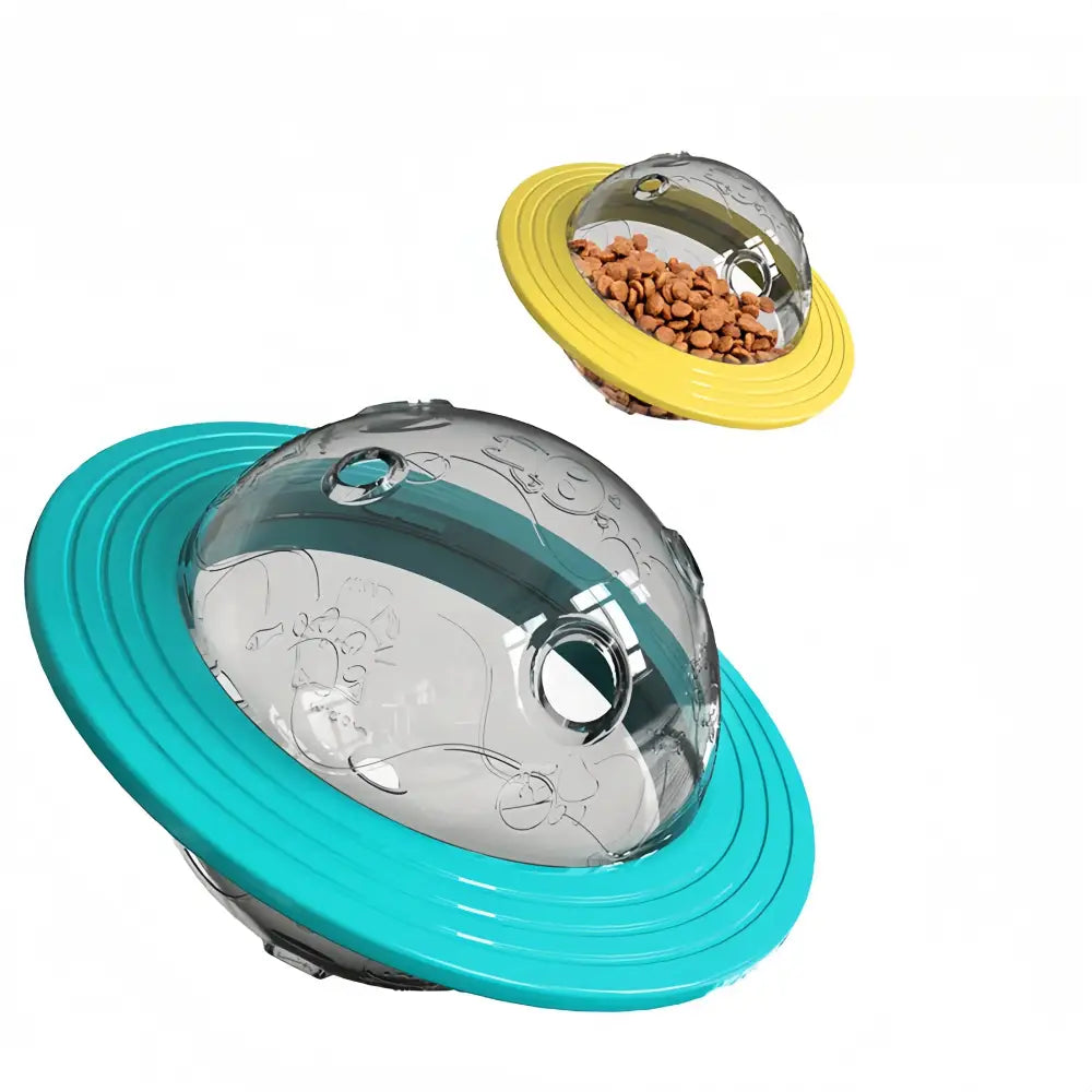 UFO-shaped pet food dispenser with a metallic dome and colorful plastic ring.