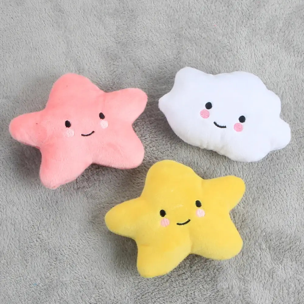 Cute plush toys shaped like stars and a cloud with smiling faces.