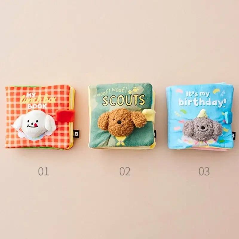 Three colorful soft fabric children’s books with animal-themed covers.