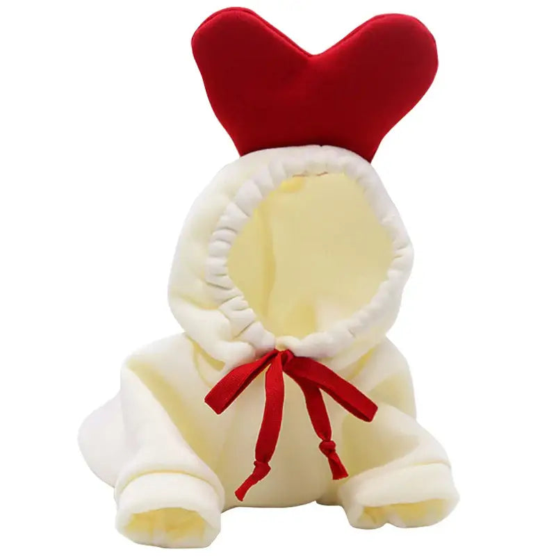 Plush toy rooster or chicken with a red heart-shaped comb and ribbon.