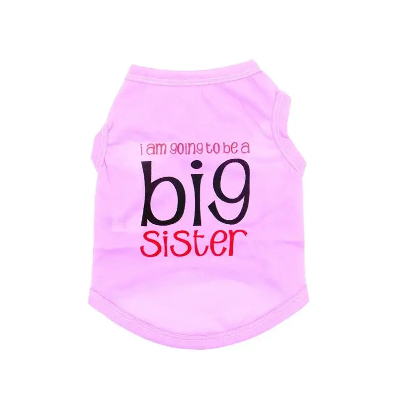 Pink sleeveless shirt with ’I am going to be a big sister’ text printed on it.