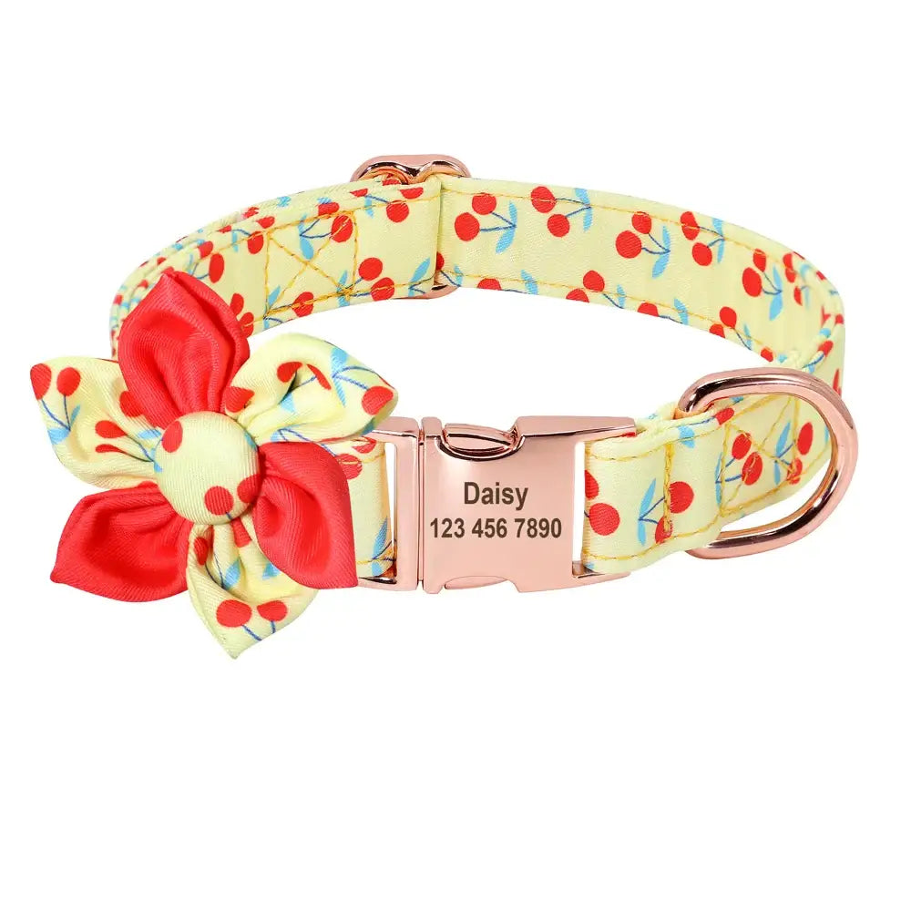 Cheerful yellow dog collar with cherry print and red bow, featuring a personalized name tag.