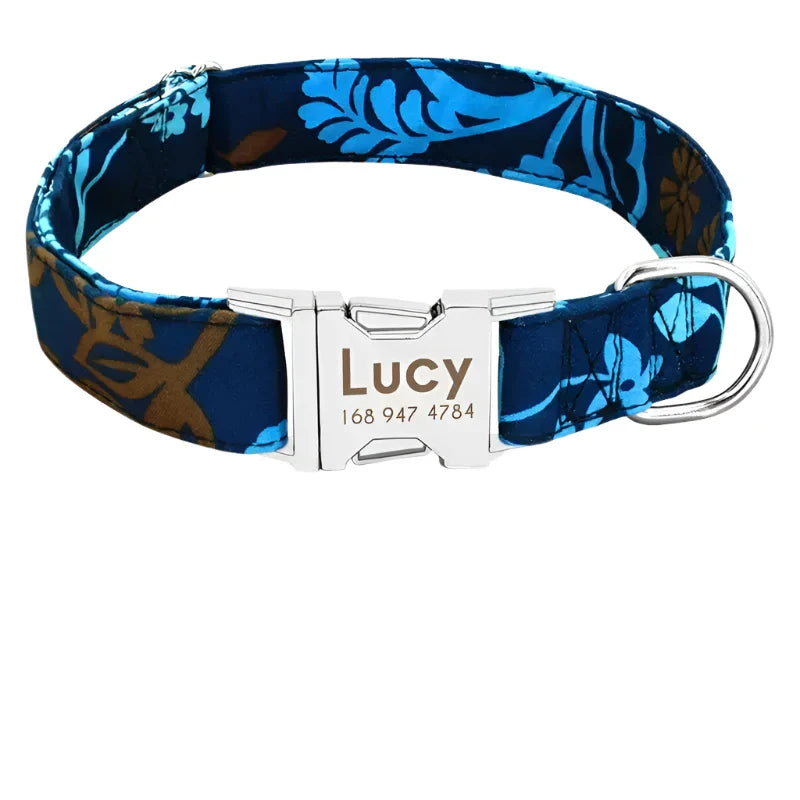 Floral patterned dog collar with a personalized metal nameplate reading ’Lucy’.