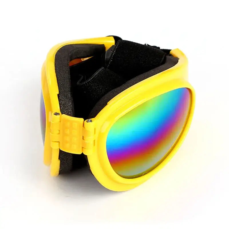 Yellow ski goggles with rainbow-tinted lenses.