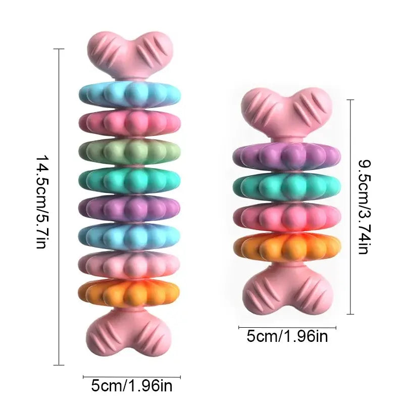 Colorful stacked toy rings with textured shapes on top and bottom.