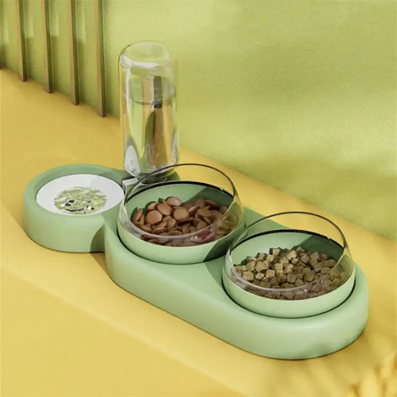 Pet feeding station with water bottle and three bowls on a green base.