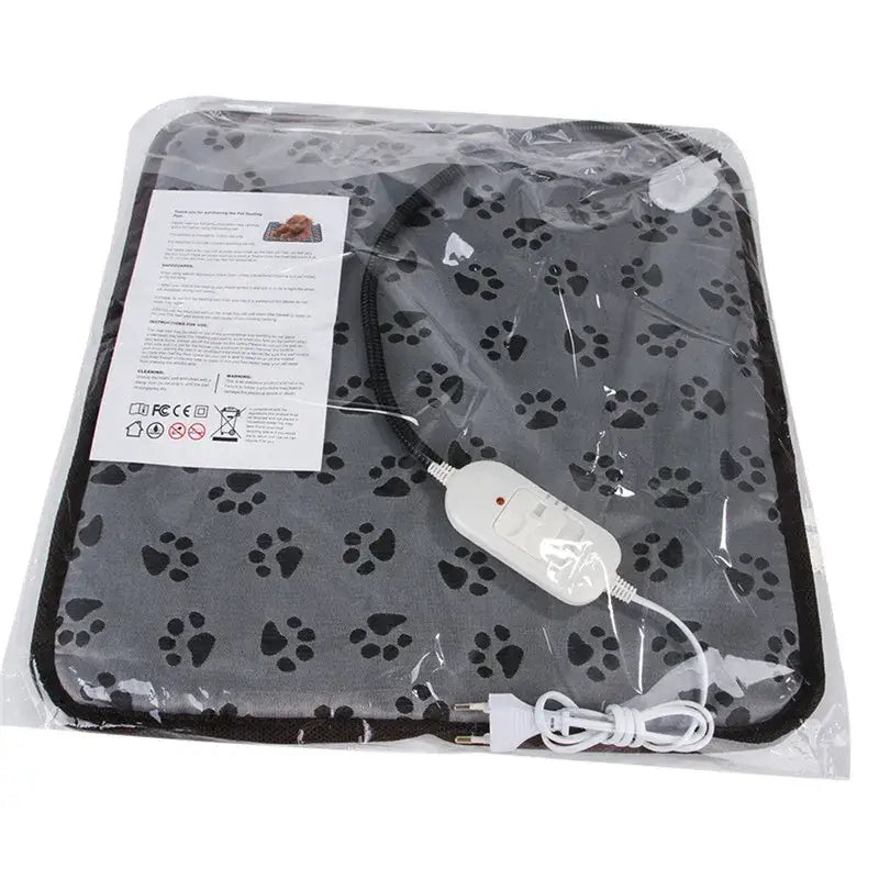 Pet heating pad with paw print pattern and attached controller.