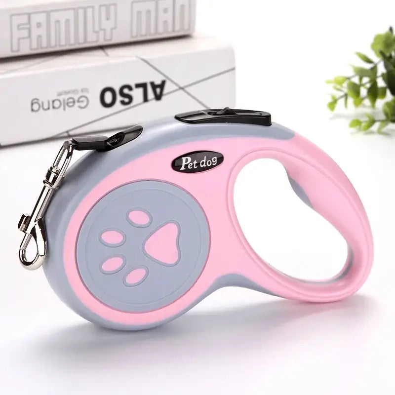 Retractable dog leash with a pink and gray design featuring a paw print pattern.