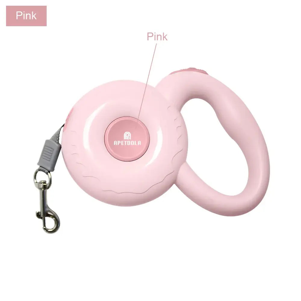 Retractable pink dog leash with a circular housing and handle.