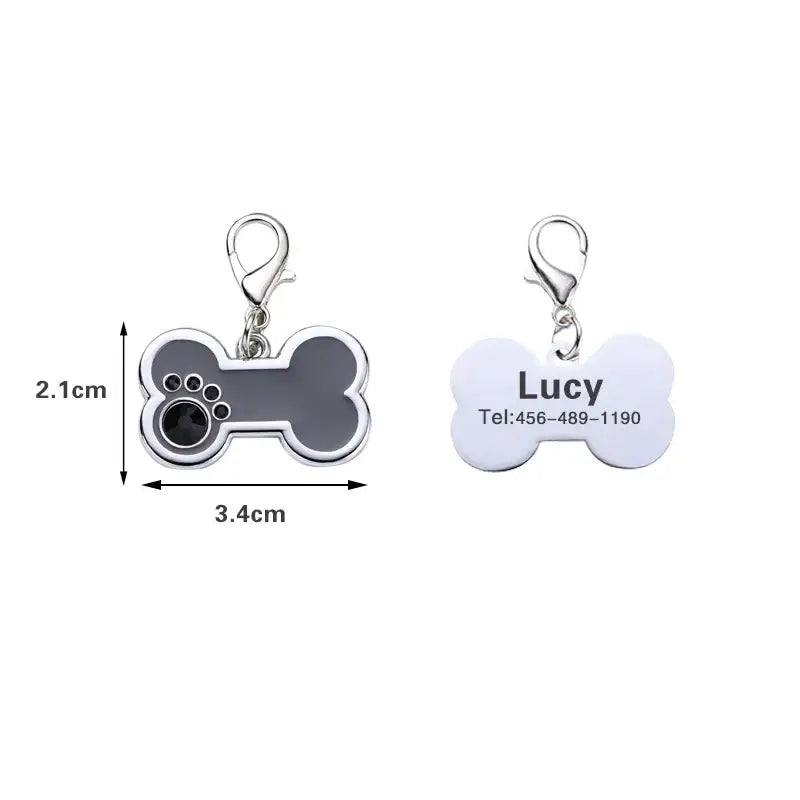 Dog tag charms shaped like bones, one with a paw print design and the other customizable with text.