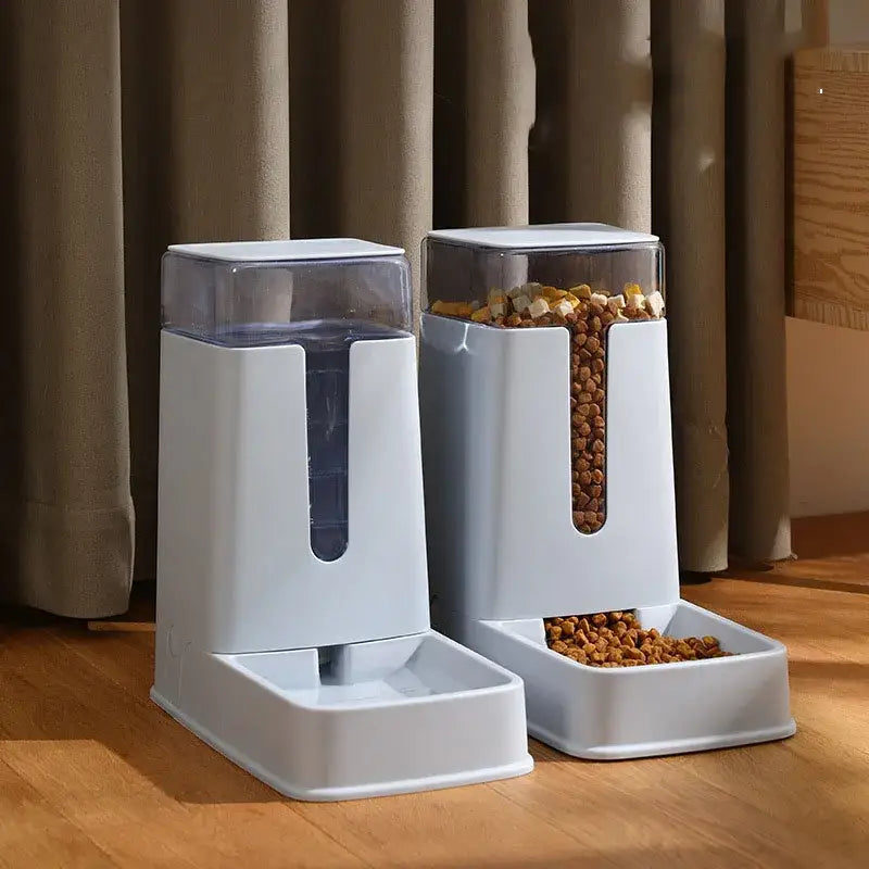 Automatic pet feeders with transparent storage containers for food and water.