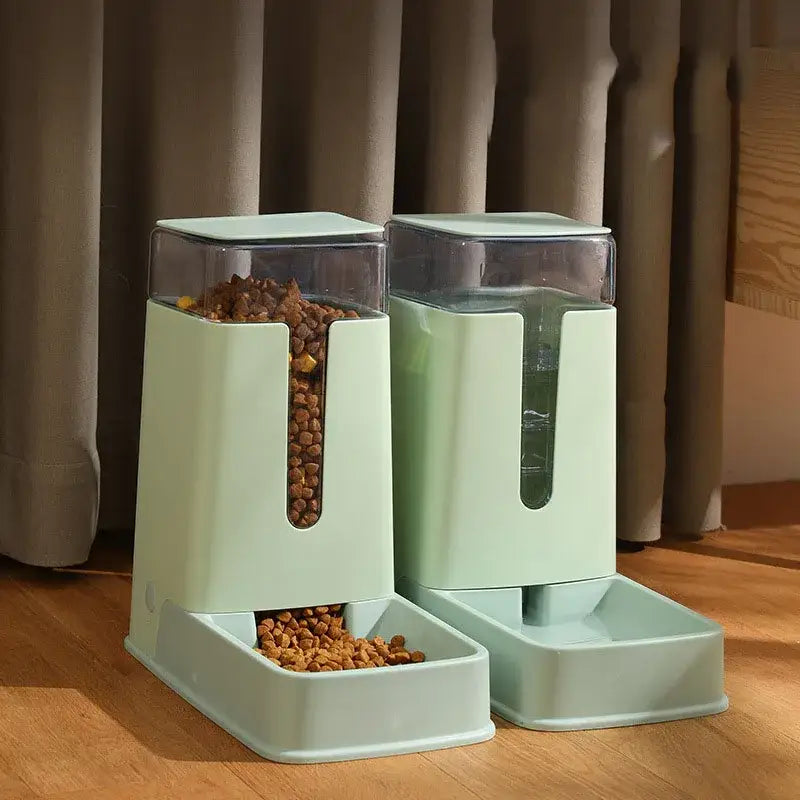 Pair of mint green automatic pet feeders with transparent storage containers.