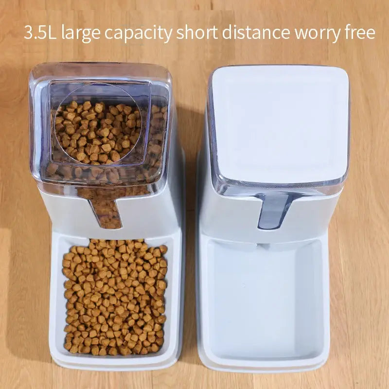 Pet food dispenser with transparent storage container and feeding tray.