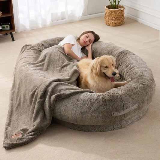 Circular plush pet bed occupied by a person and a golden retriever dog.