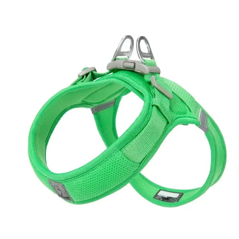 Bright green dog harness with reflective strips and metal attachment rings.