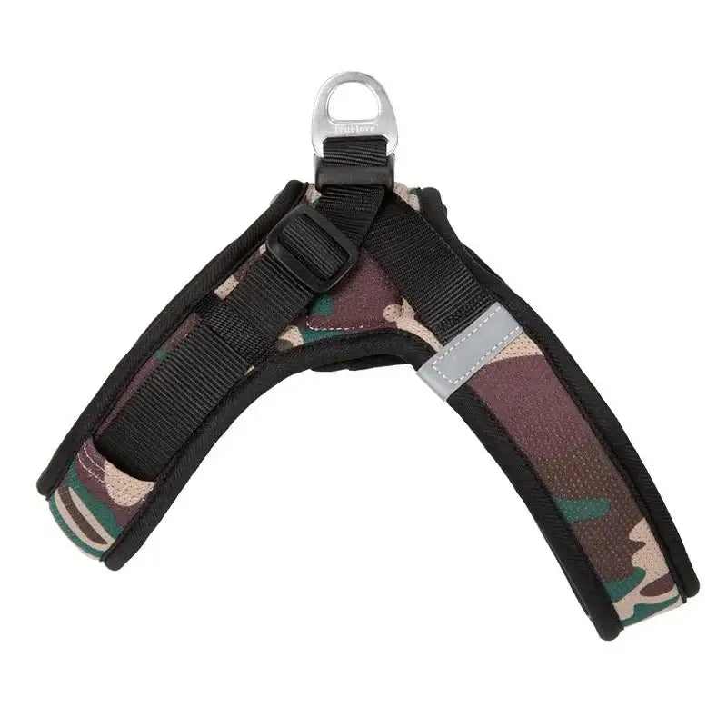 Camouflage-patterned dog harness with black straps and a metal attachment ring.