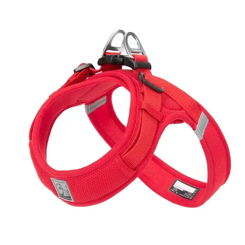 Red dog harness with reflective strips and a handle on top.