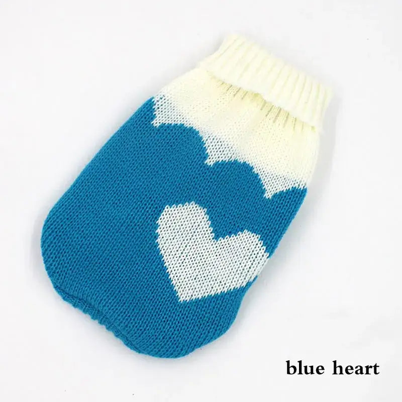 Knitted blue and white dog sweater with a heart pattern.