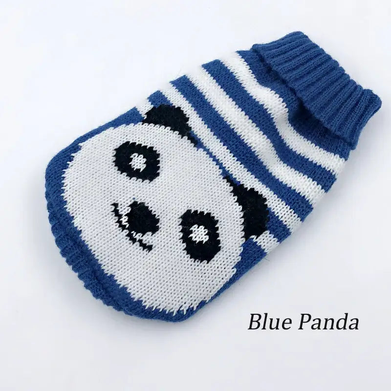 Knitted blue and white mitten with a panda face design.