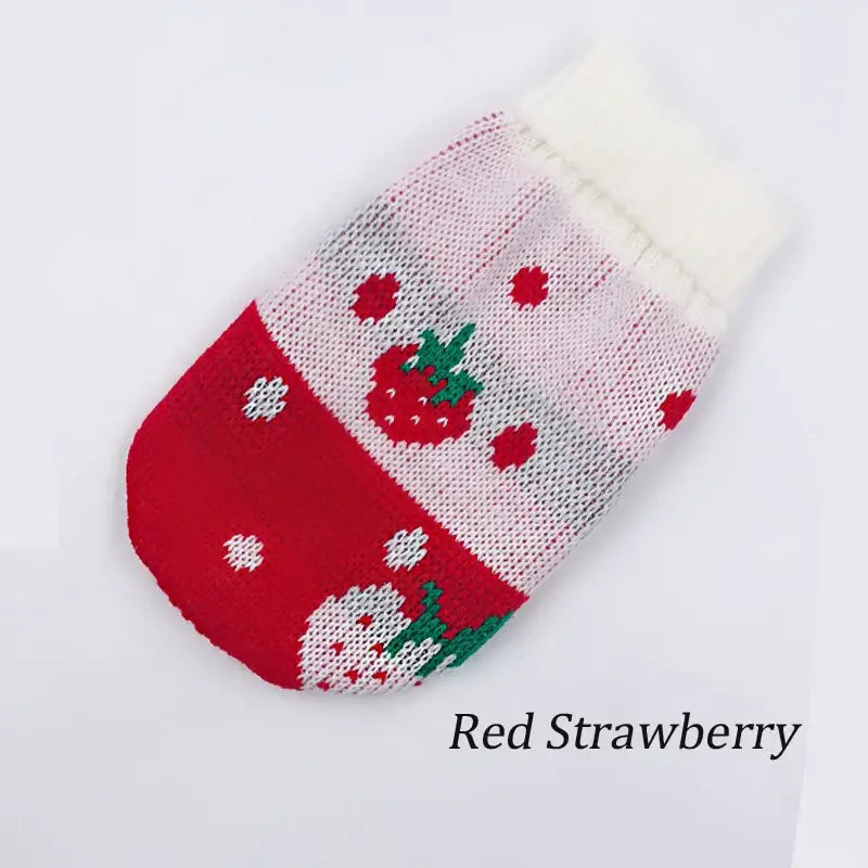 Knitted Christmas stocking with strawberry pattern and white fuzzy cuff.