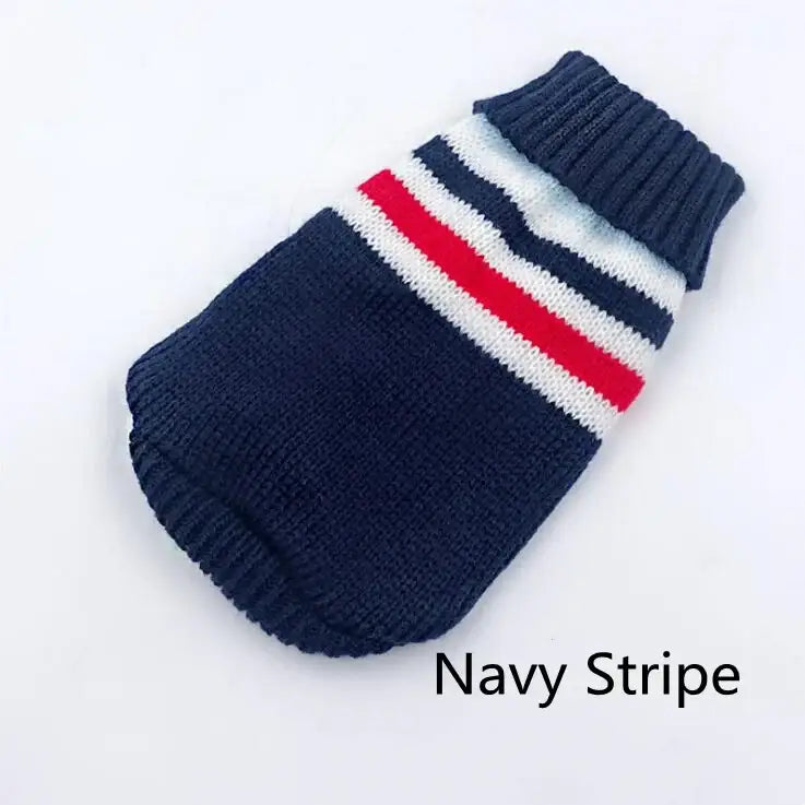 Knitted navy blue dog sweater with white and red stripes near the neck.