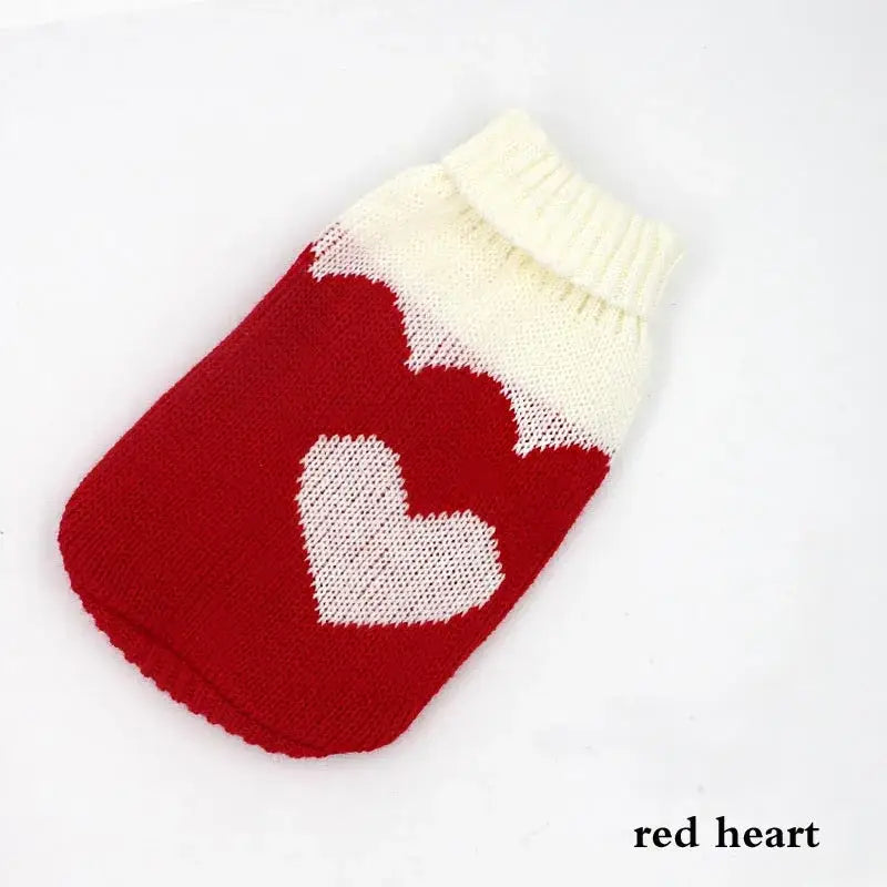 Knitted red dog sweater with a white heart pattern.