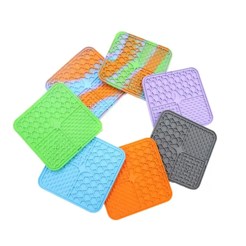 Colorful silicone pot holders or trivets arranged in a circular pattern.