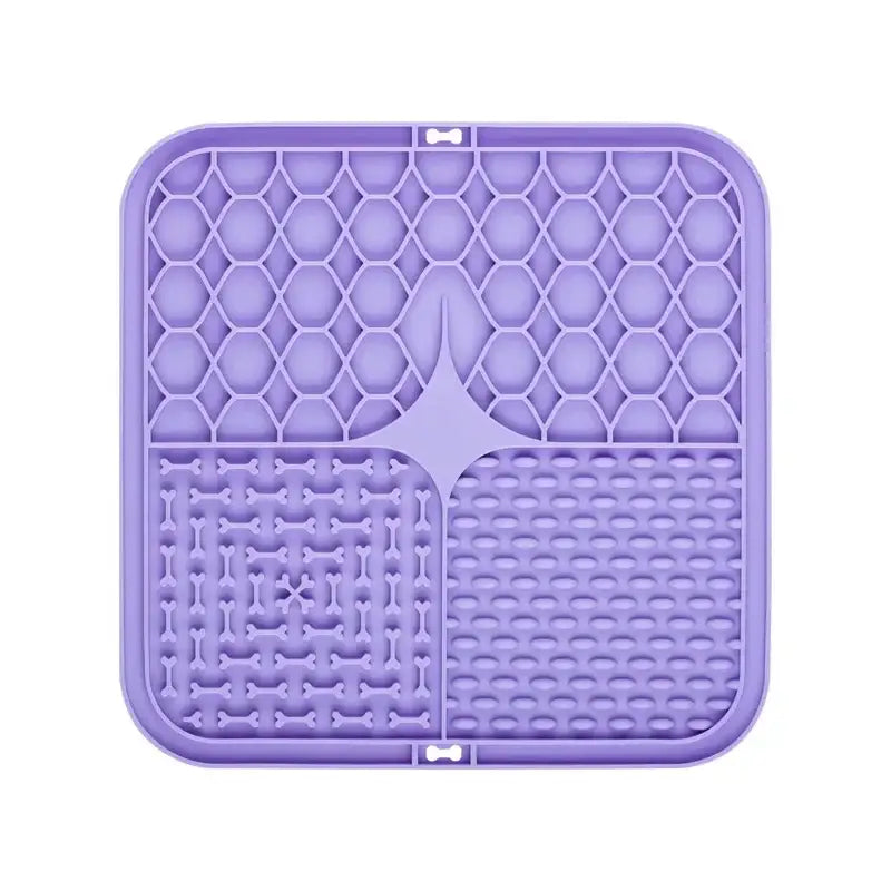 Purple silicone mat with different textured sections for cleaning makeup brushes.