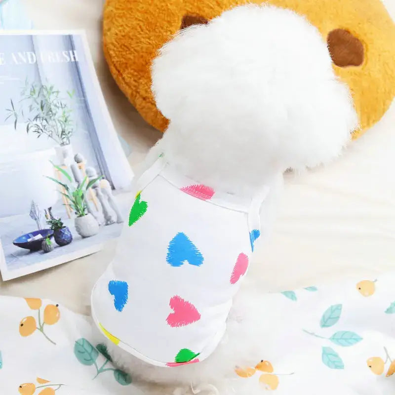 Plush toy egg with colorful heart patterns on its white surface.