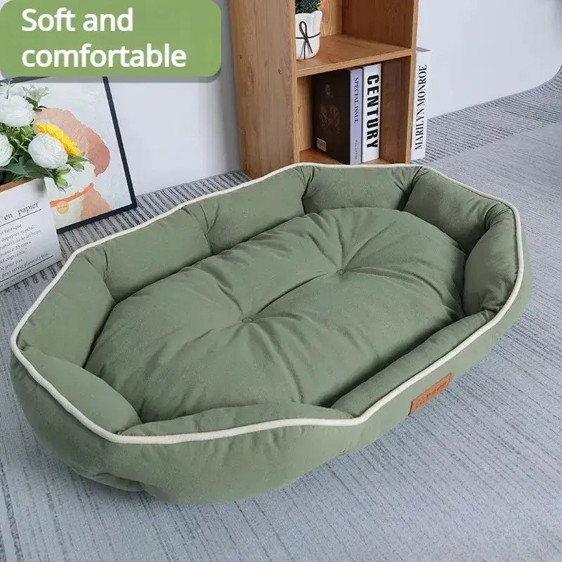 Oval-shaped green pet bed with a plush, tufted cushion and raised sides.