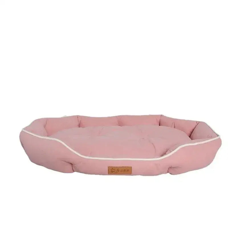 Pink oval-shaped pet bed with raised edges and a small label.