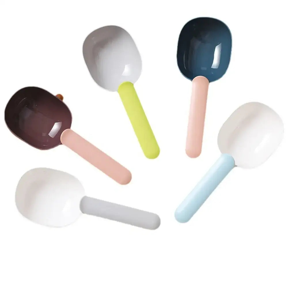 Colorful ceramic or plastic spoons with rounded heads and pastel-colored handles.