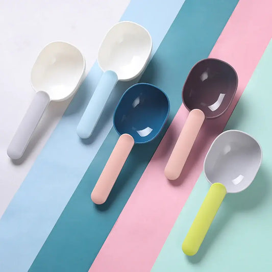 Colorful plastic measuring spoons arranged diagonally.