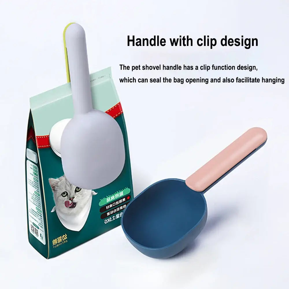 Pet food scoop with a clip-style handle designed to seal bags and facilitate hanging.