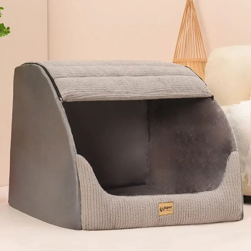 Enclosed pet bed with a gray fabric exterior and dark interior opening.