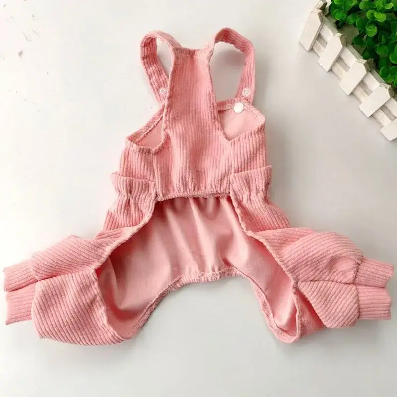 Pink ribbed dog onesie with leg openings and shoulder straps.