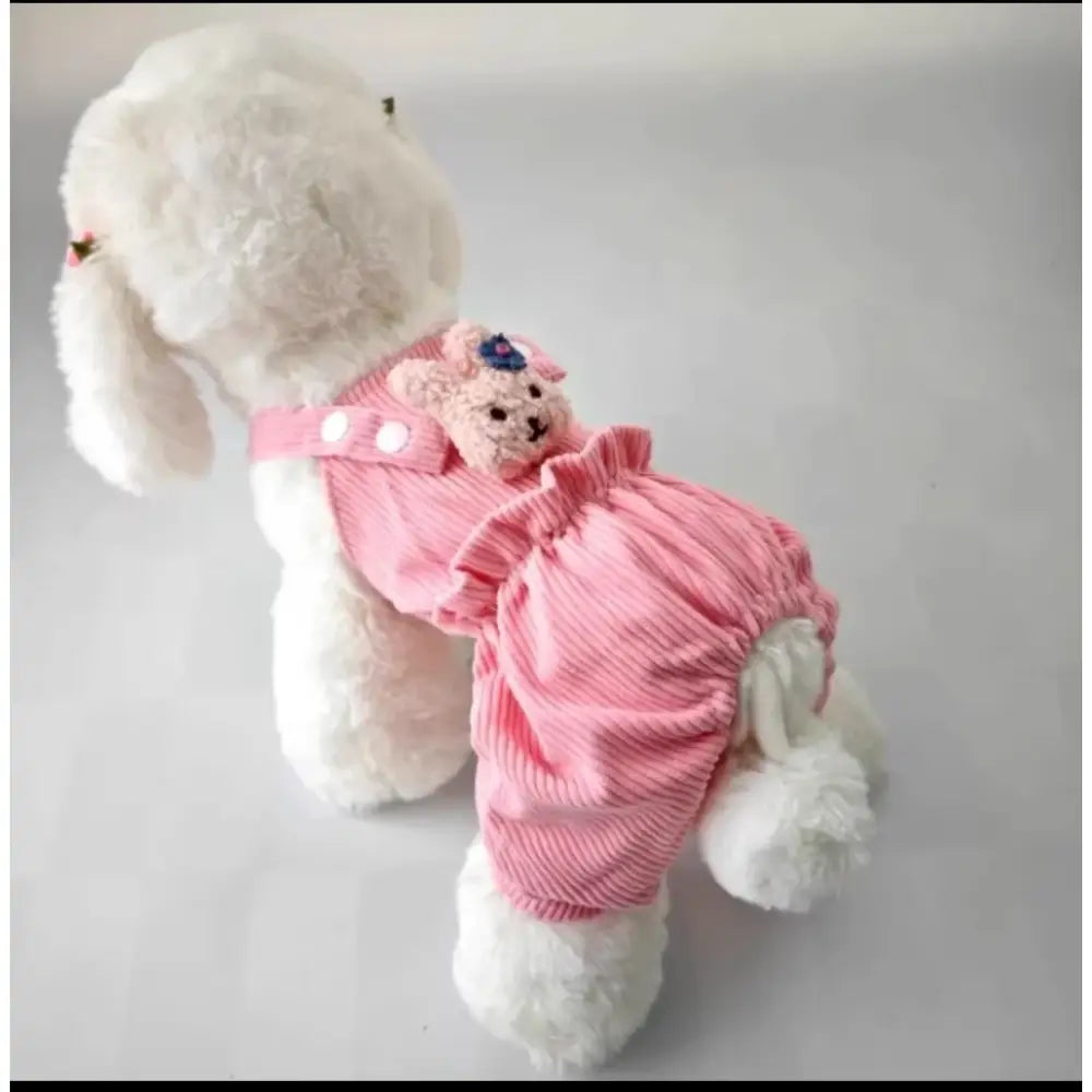 White stuffed dog wearing a pink outfit and carrying a small pink teddy bear.