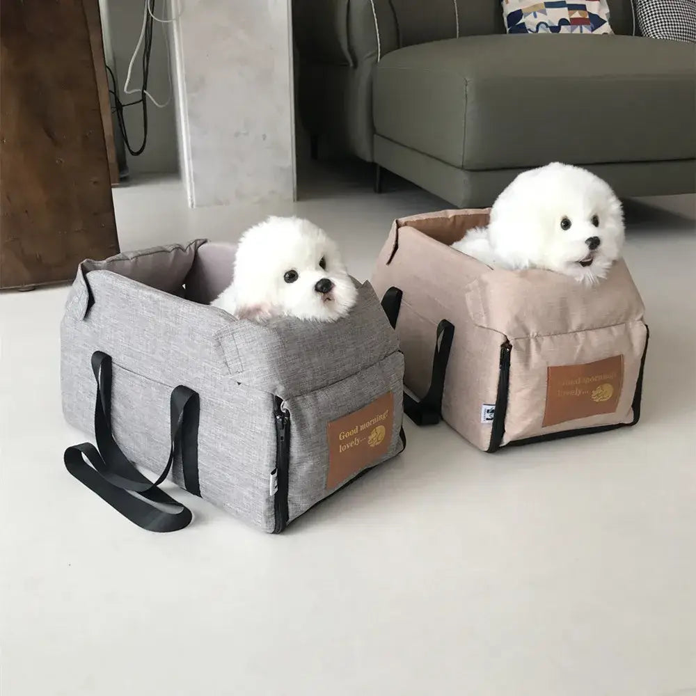 Two fluffy white puppies sitting in pet carrier bags.