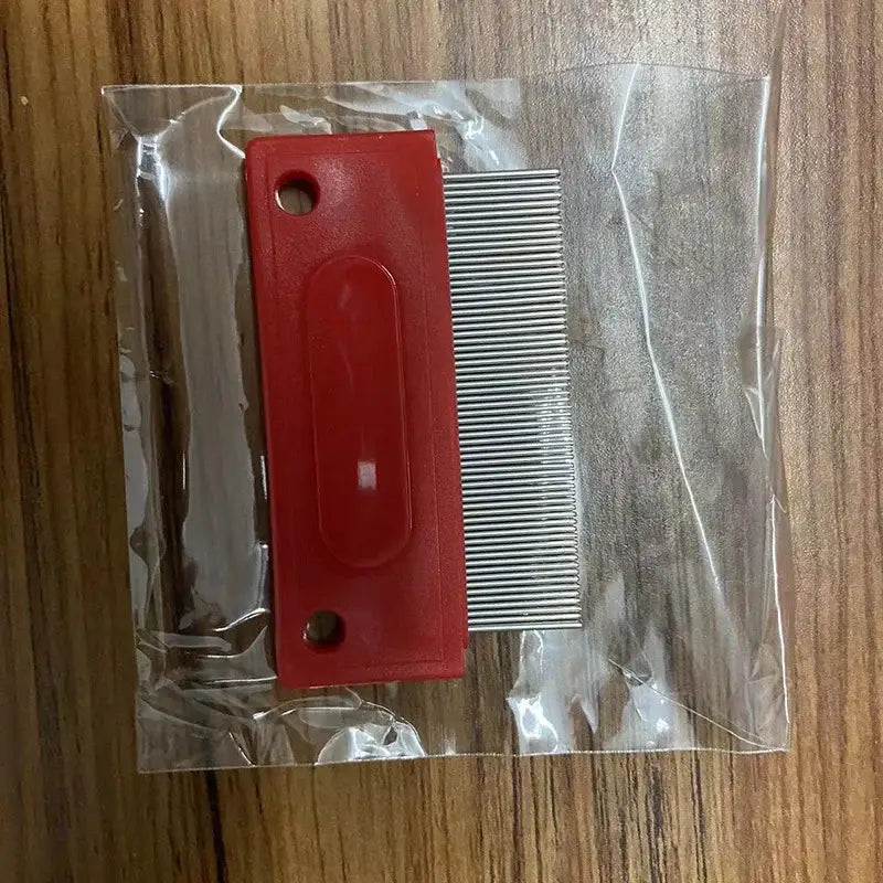 Red plastic flea comb with fine metal teeth.