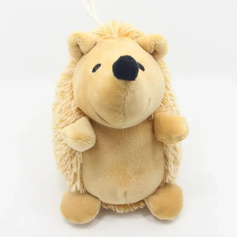 Plush toy hedgehog with light beige fur and a black nose.