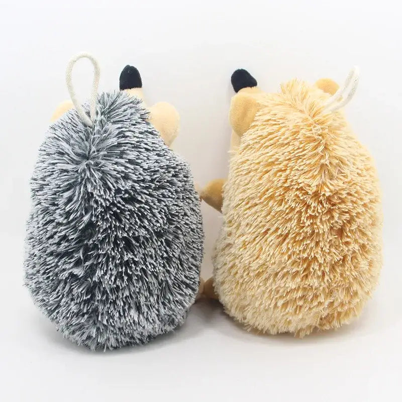 Two plush toy mice, one gray and one beige, viewed from behind.