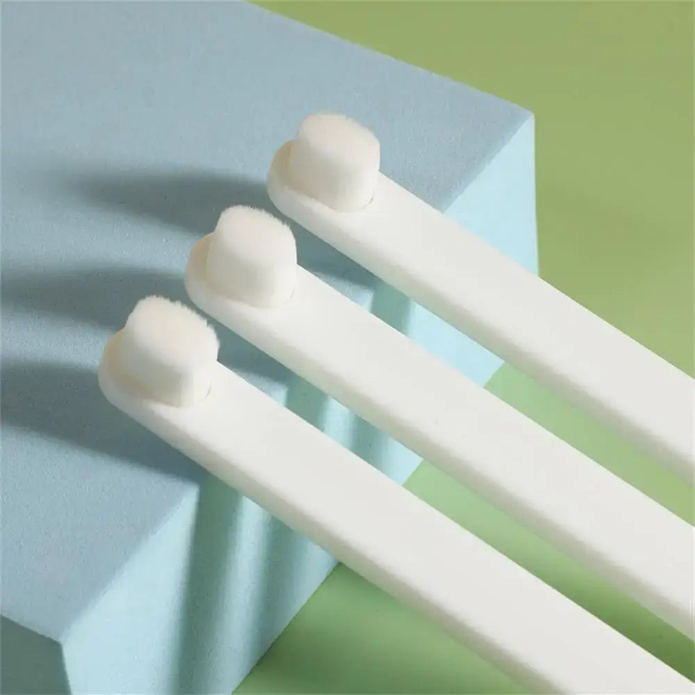 Cotton swabs with white plastic stems and cotton tips.