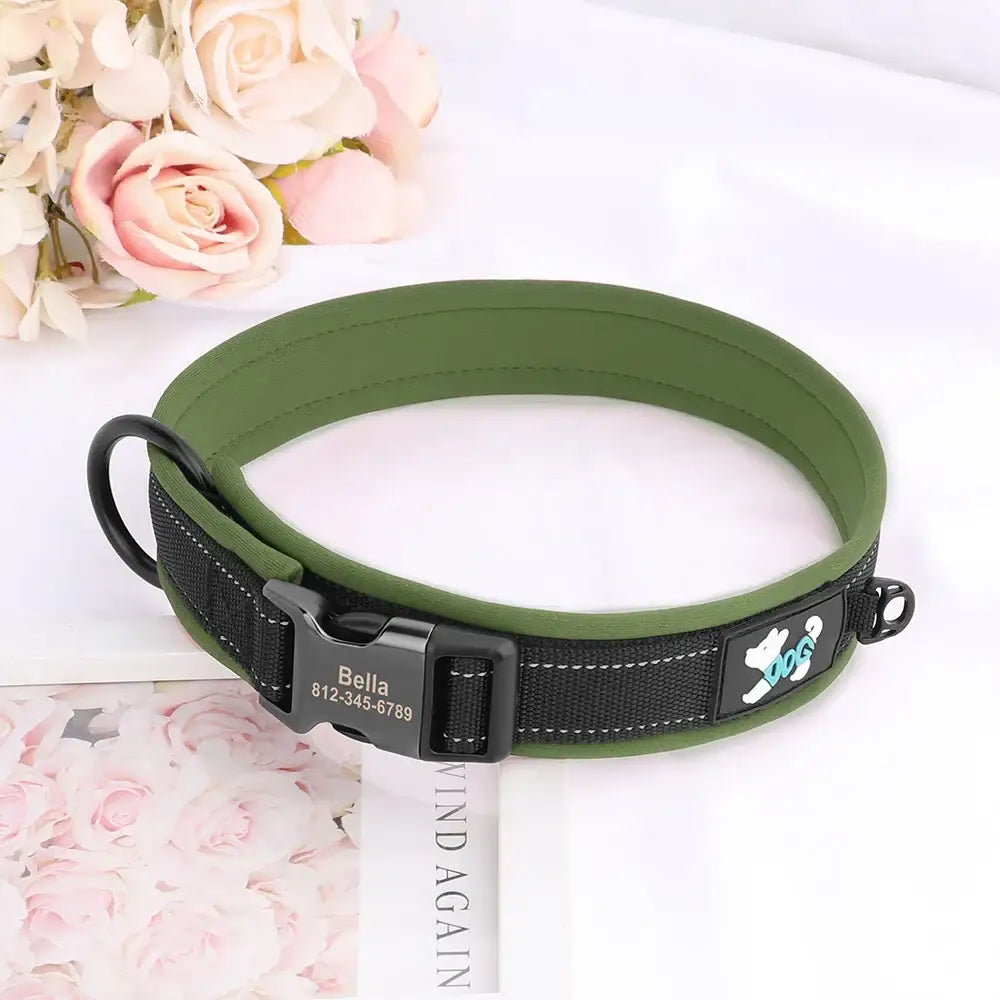 Green dog collar with a black padded section and a paw print design.